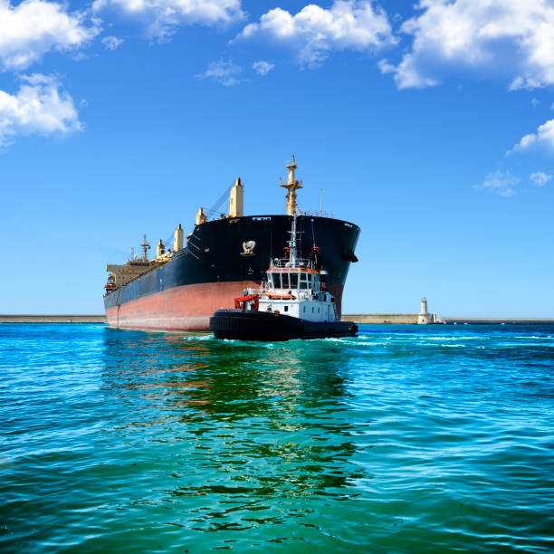 istock Tugboat helping ship in the harbor 2024588557