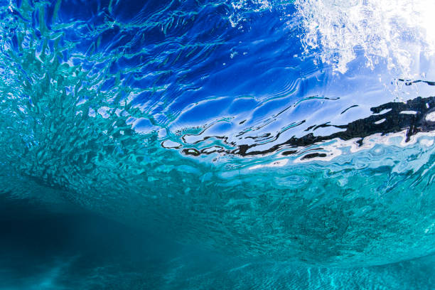 istock Surface textures swimming beneath waves in crystal clear turquoise blue ocean water on a sunny day 2024591208