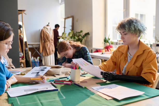istock Diverse group of girls in tailoring class at table 2024598648
