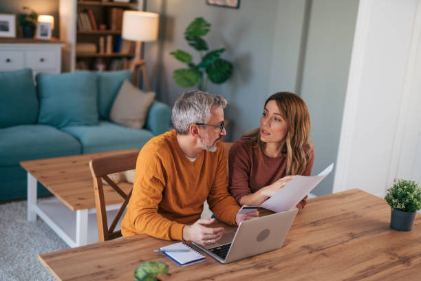 istock Frustrated couple checking bills at home using laptop 2024633737