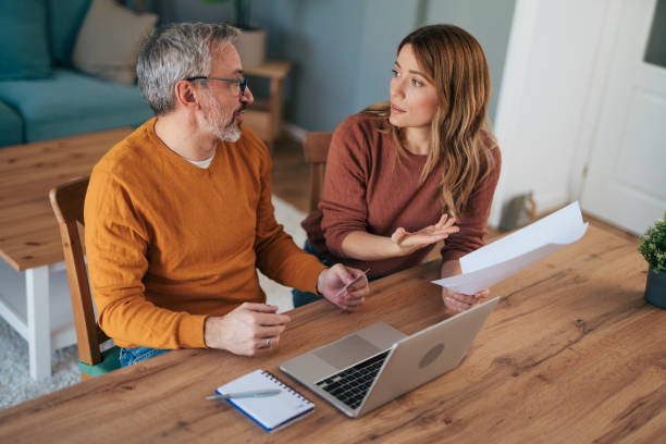 istock Frustrated couple checking bills at home using laptop 2024634286