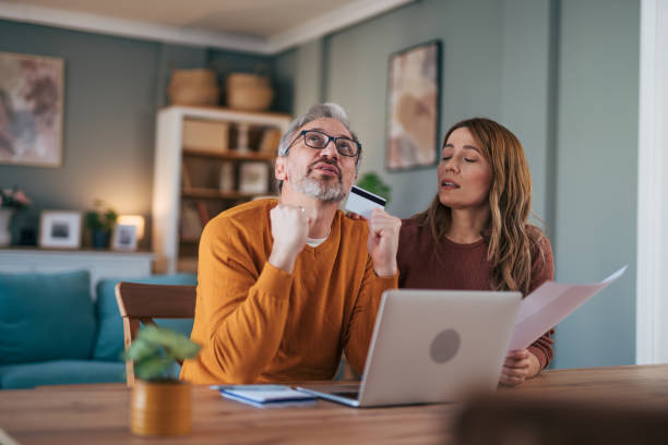 istock Frustrated couple checking bills at home using laptop 2024636342