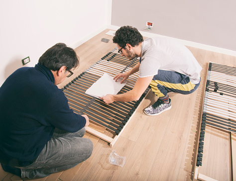 Workers assembling new bed photo