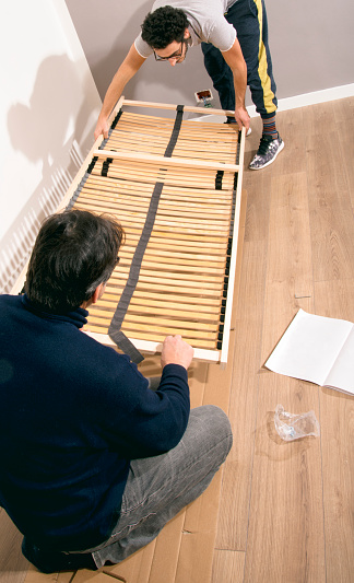 Workers assembling new bed photo