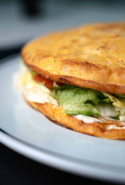istock Spanish potato omelette, vegetable omelette on white plate and black background 2024671589