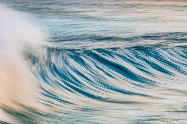 istock Slow shutter blur of smooth wave breaking on the beach with ambient soft light 2024672178