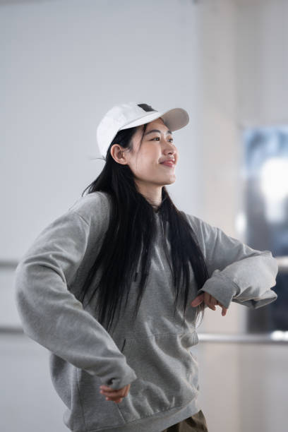 istock Beautiful female hip hop dancer in hoodie practicing at her studio 2024678677