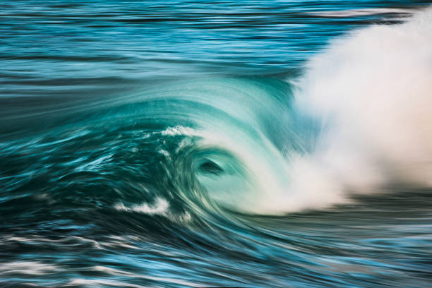 istock Slow shutter blur of smooth wave breaking on the beach with ambient soft light 2024679188