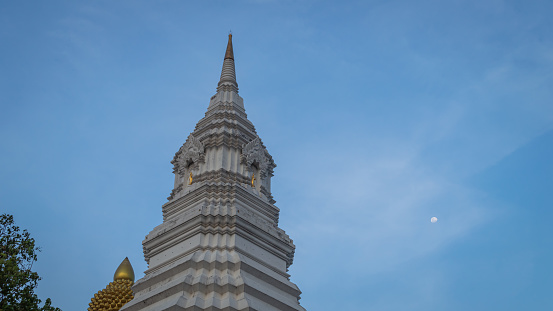 Stupa is a large white pagoda. The background is a blue sky.