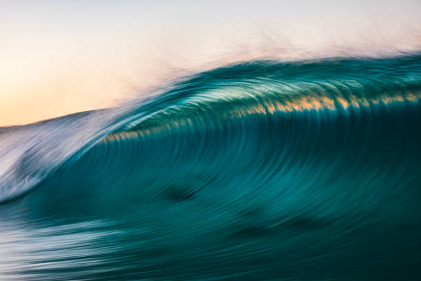 istock Motion blur of smooth ocean wave breaking in golden light 2024684101