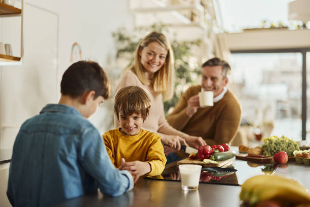 istock Happy boy having fun with his brother in the kitchen. 2024688343