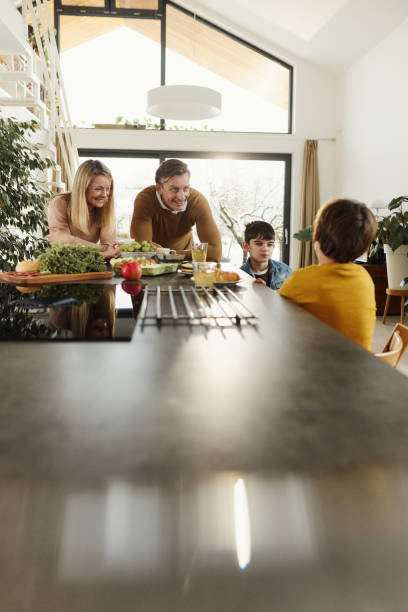 istock Happy family spending their time in the kitchen. 2024691582