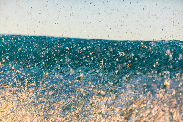 Close up texture of a breaking wave in rich golden light. Photographed in Western Australia.