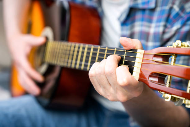 istock Hands of a young man playing the guitar. Close-up. Selective focus. 2024703389