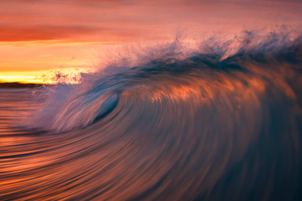 istock Motion blur of smooth ocean wave breaking in golden light 2024703399