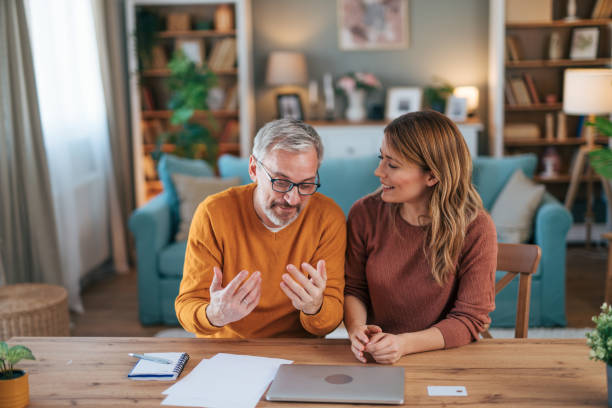 istock Frustrated couple checking bills at home using laptop 2024705055