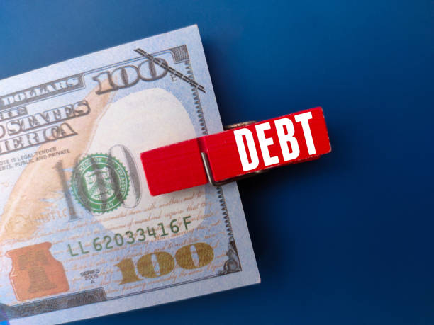 istock Banknotes and wooden clips with word DEBT 2024721474