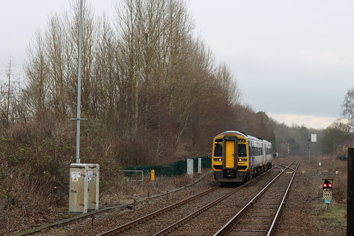 Train approaching a quiet countryside station