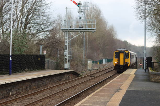 istock Train approaching a quiet countryside station 2024726386