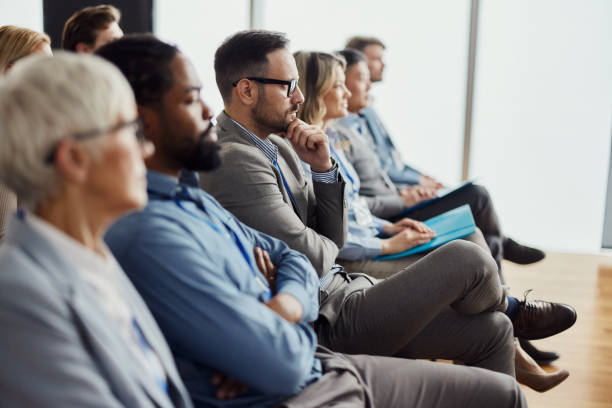 istock Pensive entrepreneur with his colleagues on education event in board room. 2024728200