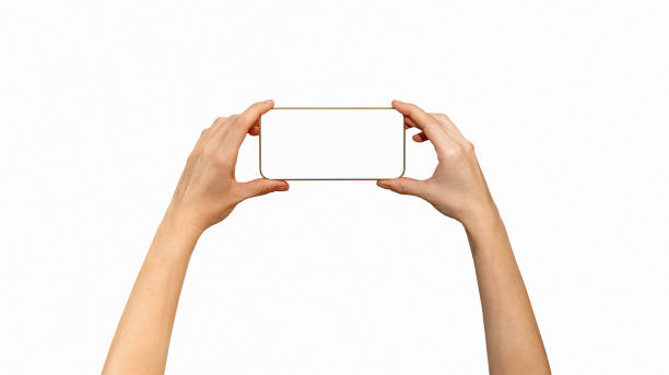 Isolated unrecognisable touchscreen mobile phone with golden yellow frame in female hands, horizontal screen position.