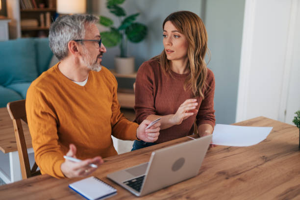 istock Frustrated couple checking bills at home using laptop 2024739648