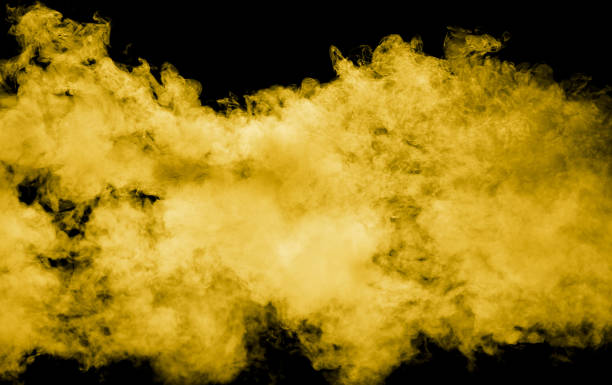 istock Yellow smoke isolated black background 2024744573
