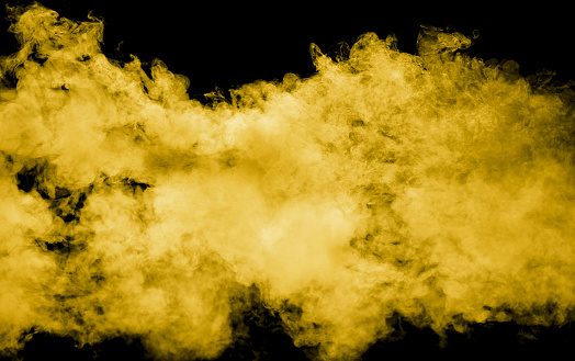 Yellow smoke isolated black background.