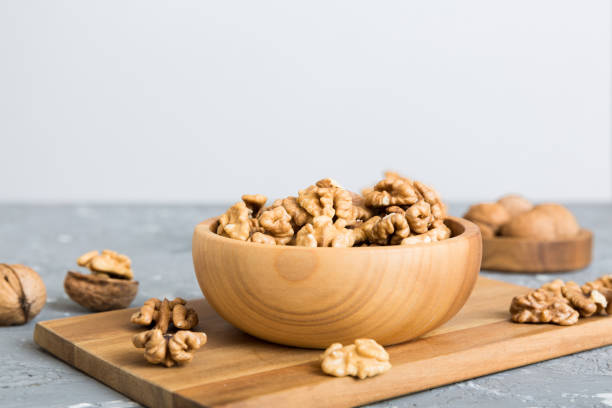 istock Fresh healthy walnuts in bowl on colored table background. Top view Healthy eating bertholletia concept. Super foods 2024750974