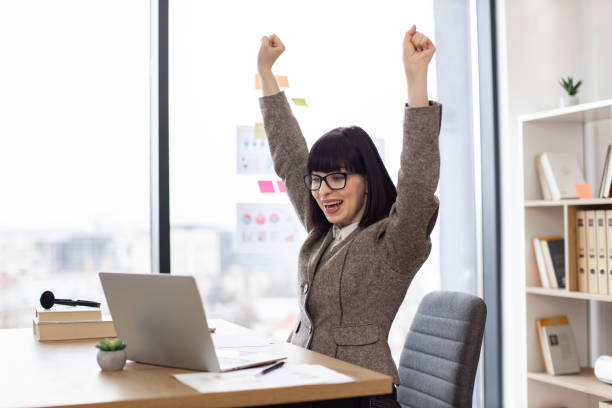 istock Emotional young lady holding hands high in air while screaming with happiness. 2024765469