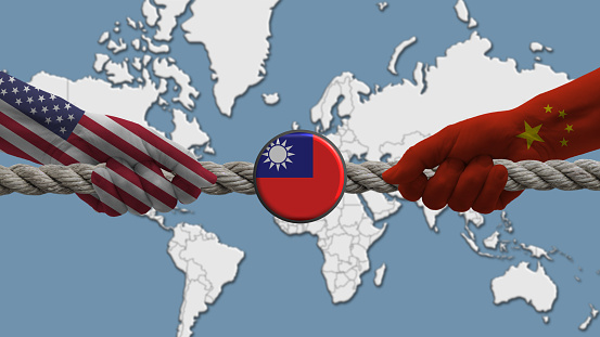 The USA and China are stretching the rope too far with Taiwan, in the background, the blurred map of the world