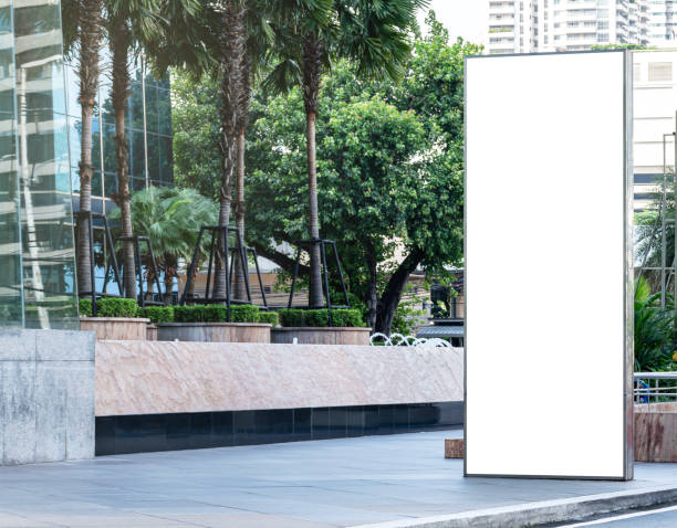 istock Outdoor vertical light box billboard on footpath with mock up white screen. Clipping path for mockup 2024807040