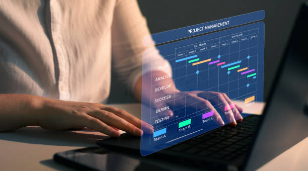 istock Project manager working on laptop and updating tasks and milestones progress planning with Gantt chart scheduling interface for company on virtual screen. Business Project Management System. 2024810256