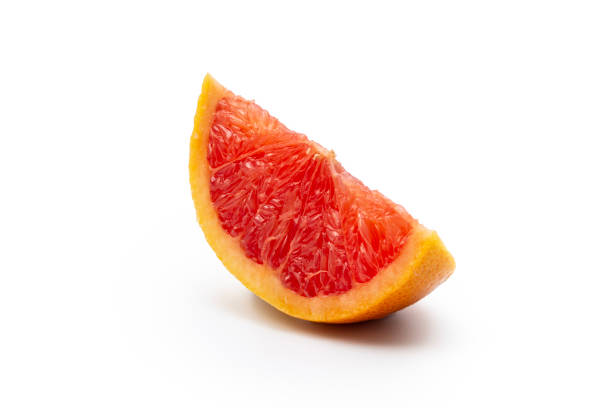 wedge of pink grapefruit citrus fruit isolated on white - cytron zdjęcia i obrazy z banku zdjęć