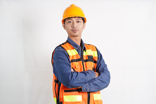Asian engineer handsome man or architect looking forward with white safety helmet. prepare modern building construction. Worker asian man working project building