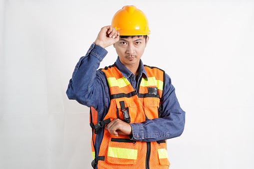 Asian engineer handsome man or architect looking forward with white safety helmet. prepare modern building construction. Worker asian man working project building