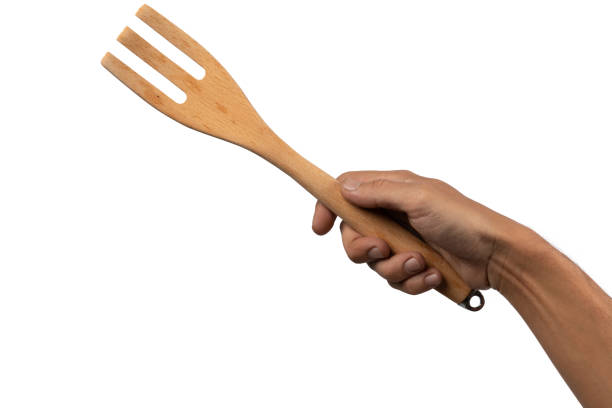 istock Hand holding wooden fork on white background cutout 2024846106
