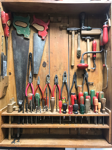 Different types of work tools arranged in workshop.