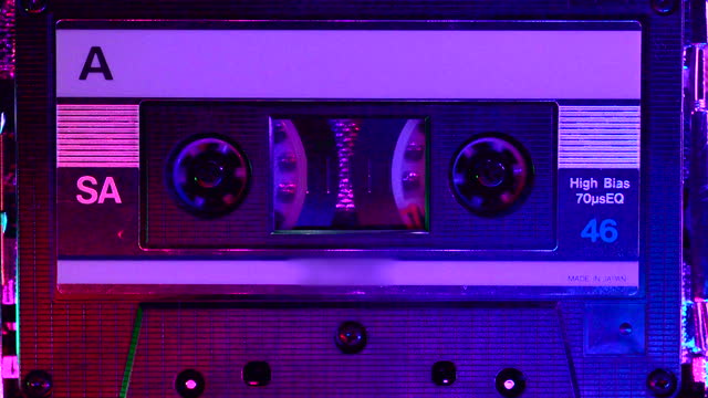 Colorful lighting in the club illuminating the cassette tape being played