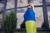 Woman holding a yellow and blue flag of Ukraine in outdoors. Independence Day. Flag Day.