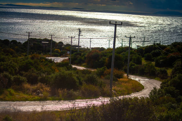 Embarking on a coastal journey: A road leading to the sea, promising an adventurous exploration of nature's beauty where the road meets the waves