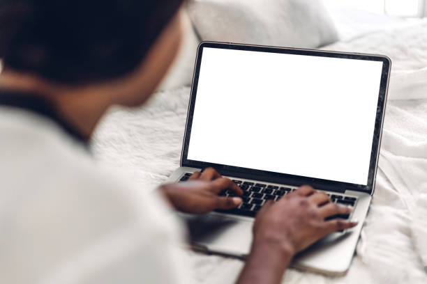 istock Young african american black woman relaxing and using laptop computer with white mockup blank screens.woman checking social apps and working.Communication and technology concept 2024890248