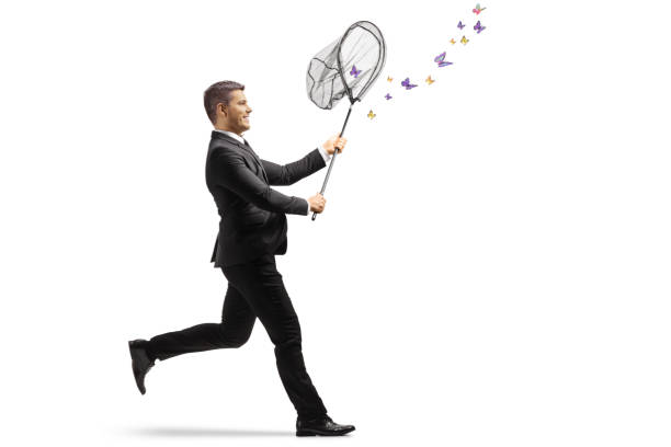 istock Businessman running and catching butterflies with a net 2024892437