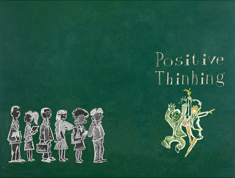 Positive thinking concept on green blackboard