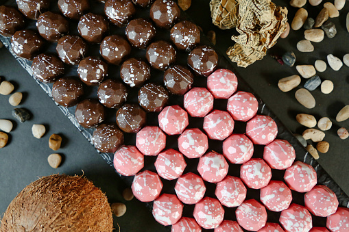 A variety of chocolates and nuts arranged neatly on a table, creating a tempting display of indulgent treats.