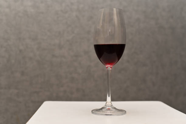 istock red wine in a glass. close-up on a gray background 2024919471