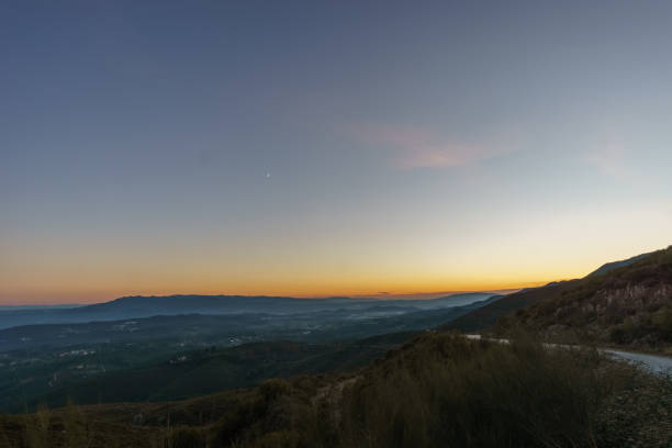View from Serra da Arada over mountain landscape at evening twilight with crescent moon, Sao Pedro do Sul, Portugal