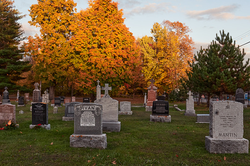 Old Chelsea, Quebec, Canada; 17th of October, 2023. The cemetery of Old Chelsea village in an autumn sunset