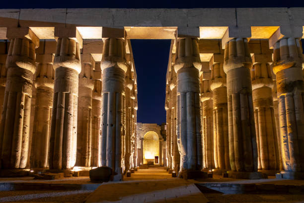 Great columns hall in Luxor temple illuminated at night, in Luxor, Egypt