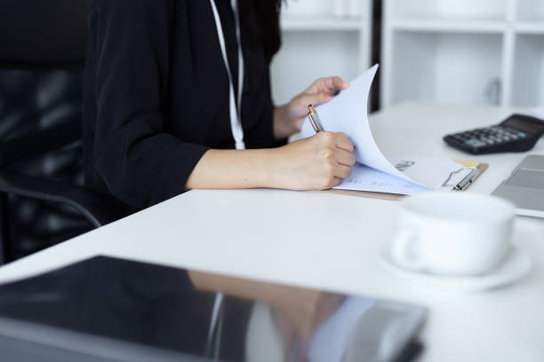 istock Female accountant working about financial with calculator at her office, Savings, Finances and economy concept 2024960436